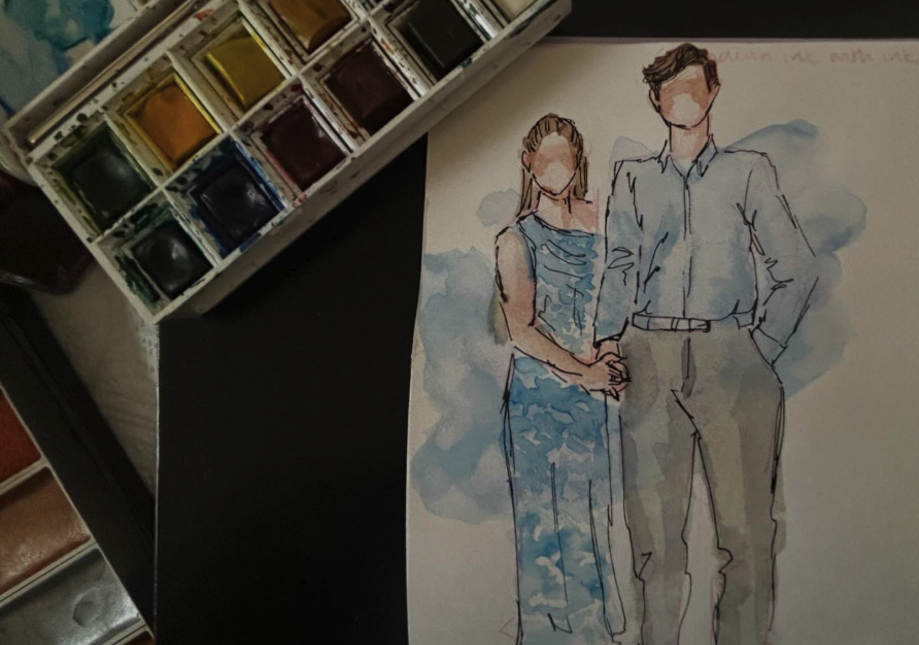 A lay flat with a watercolour illustration of a man and woman taking up the right handside with two palettes lying diagonal on the left hand side. 
